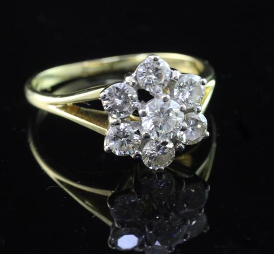 An 18ct gold and seven stone diamond cluster ring, size P.